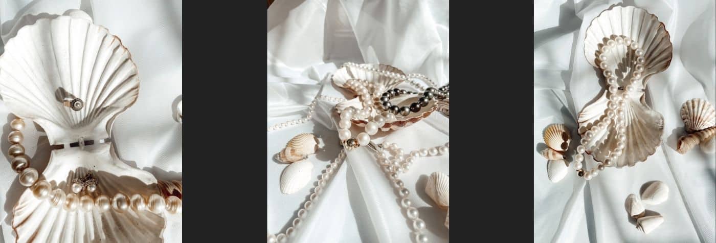 Perlenschmuck liegt in einer Muschel auf einem weißen Tuch